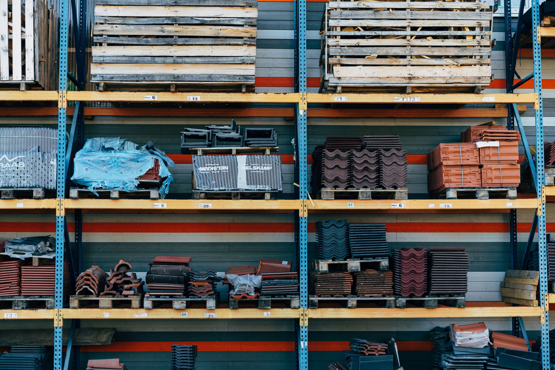 Construction materials arranged on warehouse shelves